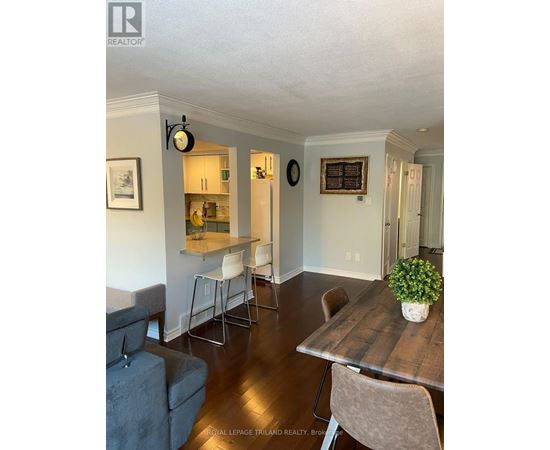 A dining room with a wooden table and chairs.