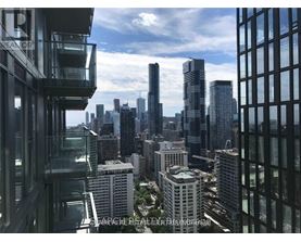 A cityscape with tall buildings and a clear sky.