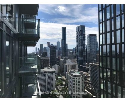 A cityscape with tall buildings and a clear sky.