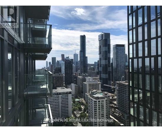 A cityscape with tall buildings and a clear sky.