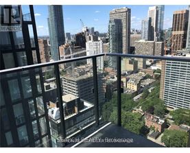 A view from a high-rise building looking out over a cityscape.