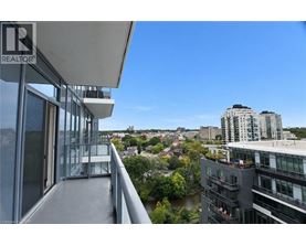 A balcony overlooks a cityscape with a river and buildings.
