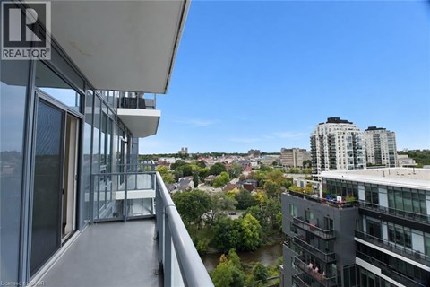 A balcony overlooks a cityscape with a river and buildings.