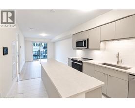 A modern kitchen with white cabinets and appliances.