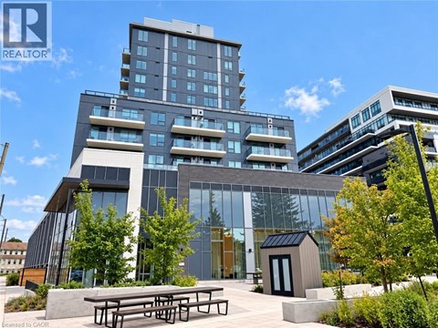 A modern building with glass windows and a wooden entrance.