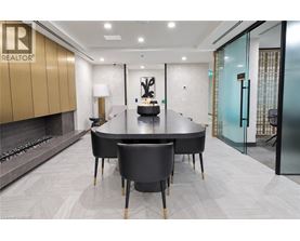 A modern dining room with a large table and chairs.