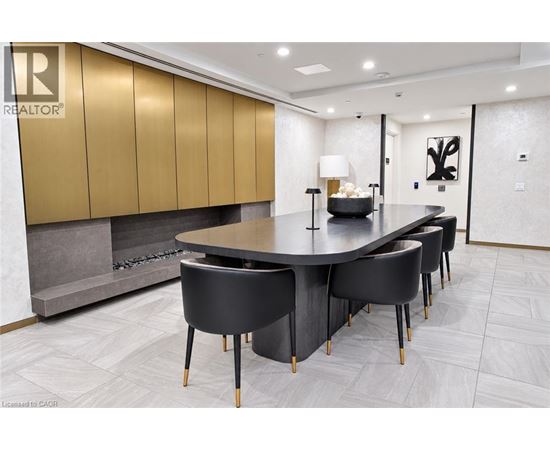 A modern dining room with a large table and chairs.