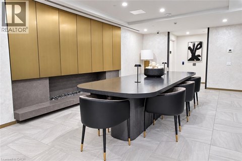 A modern dining room with a large table and chairs.