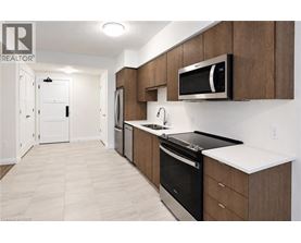 A modern kitchen with wooden cabinets and stainless steel appliances.