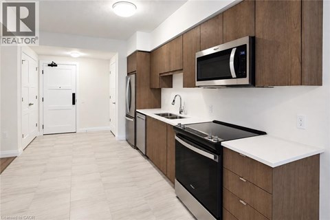 A modern kitchen with wooden cabinets and stainless steel appliances.