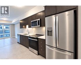 A modern kitchen with stainless steel appliances and wooden cabinets.