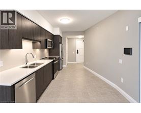 A modern kitchen with a sink, microwave, and refrigerator.