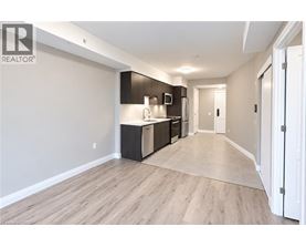 A spacious kitchen with dark brown cabinets and stainless steel appliances.