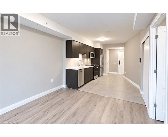 A spacious kitchen with dark brown cabinets and stainless steel appliances.