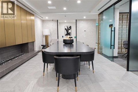 A modern dining room with a large table and chairs.