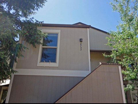 A house with a brown roof and a white window.