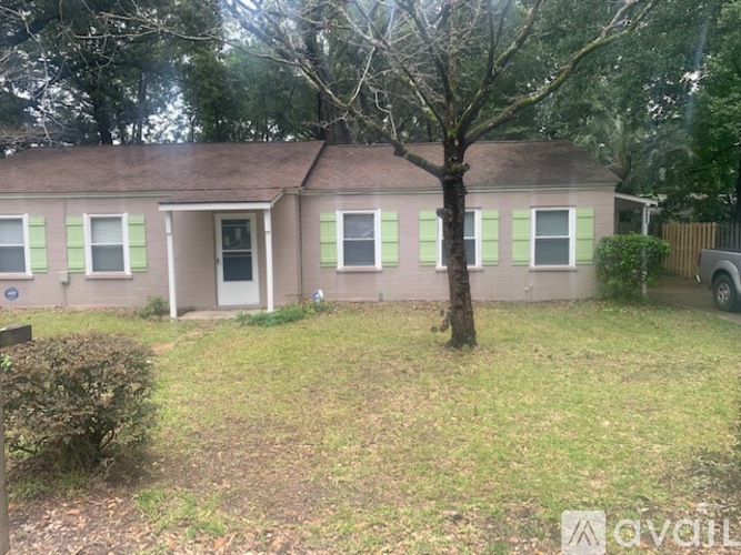 A small house with a tree in front of it.