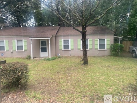 A small house with a tree in front of it.