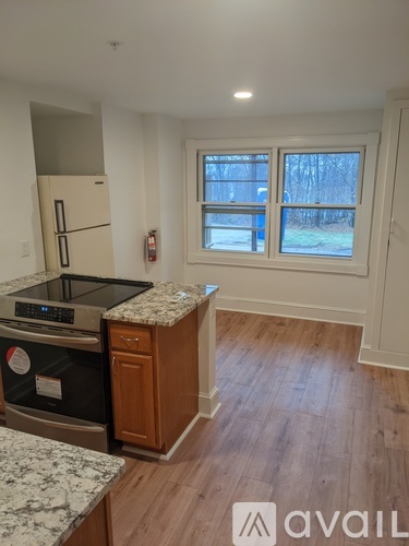 A kitchen with a granite countertop and a window.