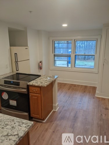 A kitchen with a granite countertop and a window.