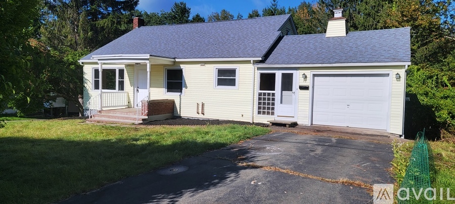 A small house with a garage is for sale.