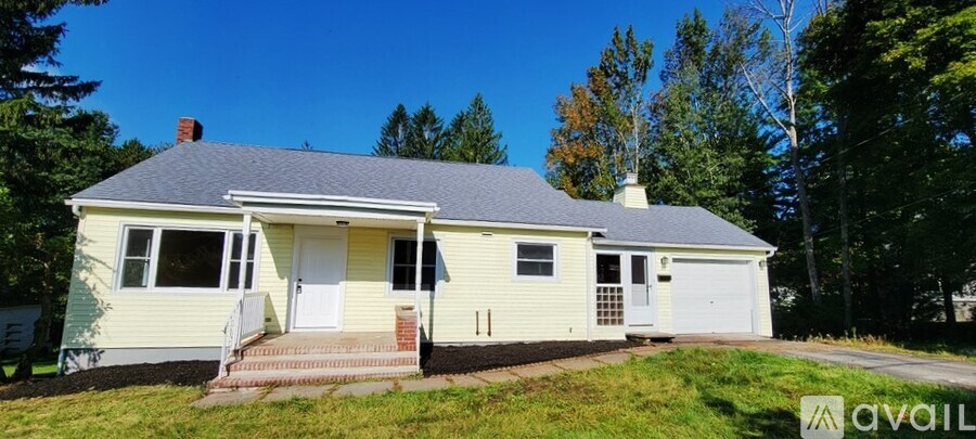 A two-story house with a garage is for sale.