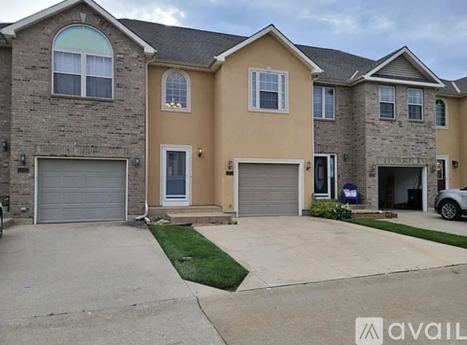 A house with a garage and a driveway in front.
