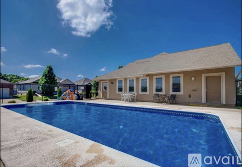 A house with a pool in front of it.