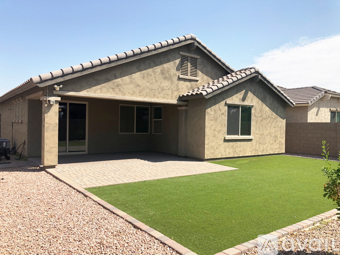 A house with a patio and a small garden.