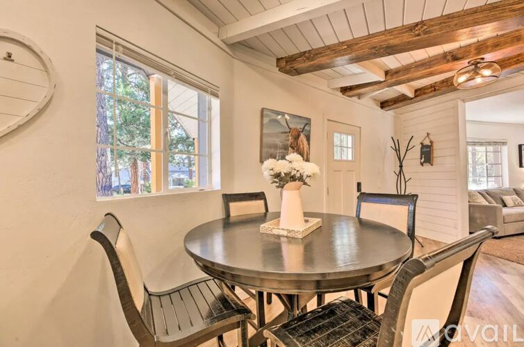 A dining room with a round table and chairs.