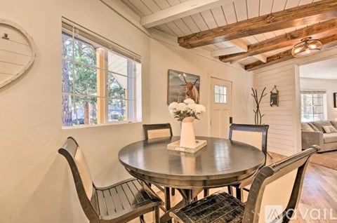 A dining room with a round table and chairs.