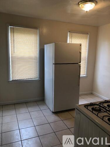 A kitchen with a white fridge and a white stove.