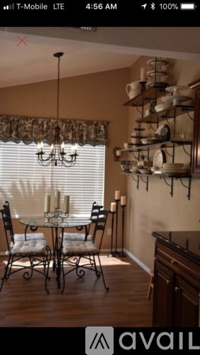 A dining room with a table set for four.