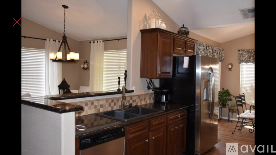 A kitchen with wooden cabinets and a black countertop.