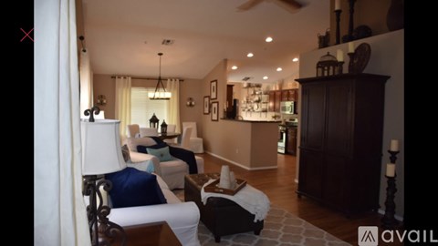 A living room with a white sofa and a wooden coffee table.