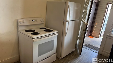 A white stove and refrigerator in a kitchen.