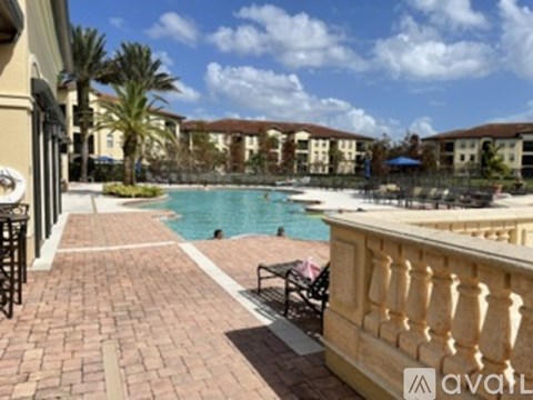 A pool area with a bench and a fence.