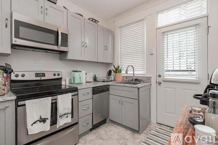 A kitchen with a stove, microwave, and cabinets.