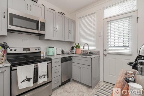 A kitchen with a stove, microwave, and cabinets.