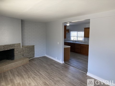A living room with a fireplace and wooden flooring.