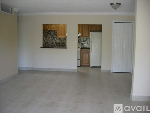 A spacious room with a stone wall and a white door.