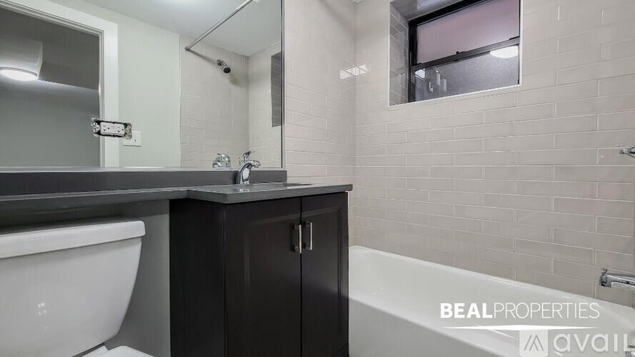 A bathroom with a white toilet, a sink, and a bathtub.