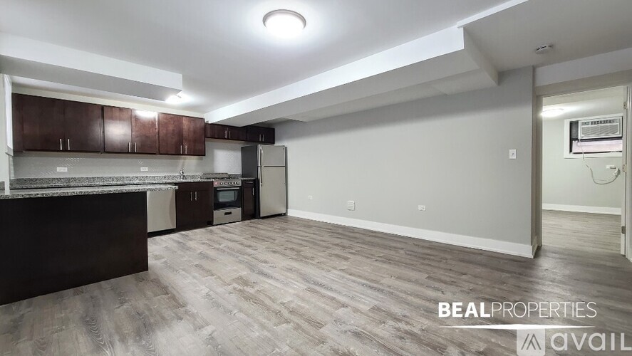 A kitchen area with brown cabinets and a refrigerator.