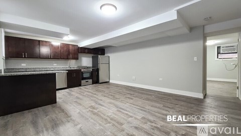 A kitchen area with brown cabinets and a refrigerator.