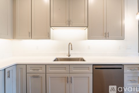 A kitchen with a sink and a dishwasher.