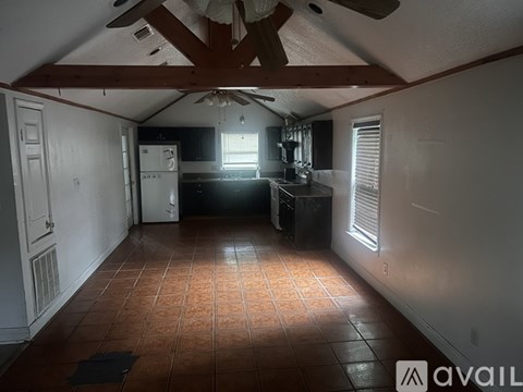 A kitchen with a refrigerator, microwave, and oven is shown in the image.