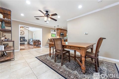 A dining room with a wooden table and chairs.