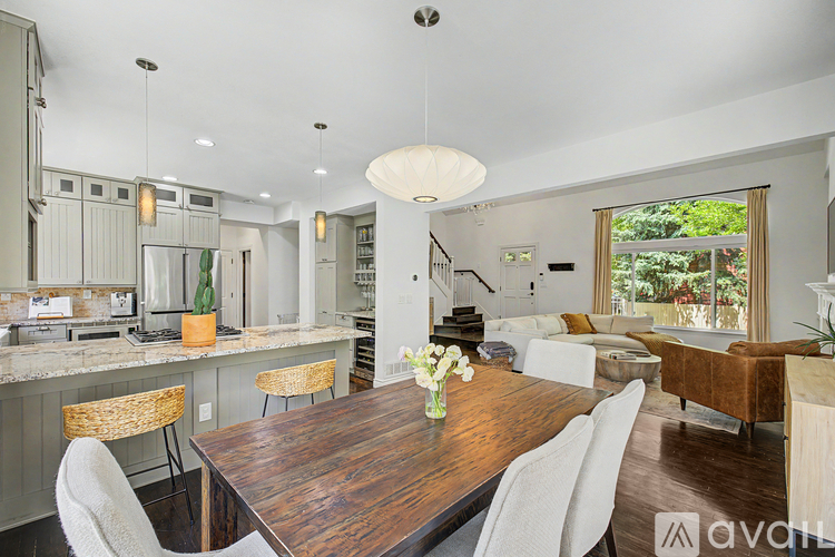 A modern kitchen with a wooden table and chairs.