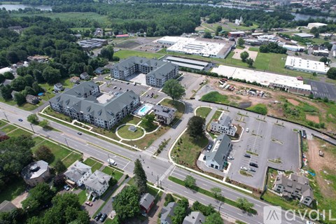 An aerial view of a large building complex surrounded by a parking lot and other buildings.