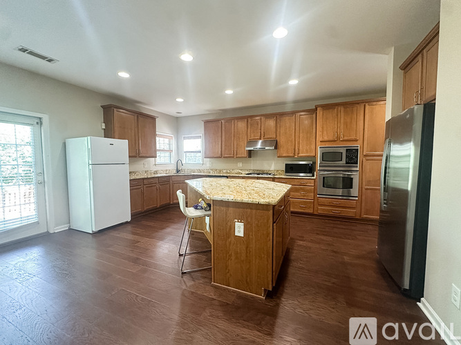 A kitchen with wooden cabinets and a granite countertop.